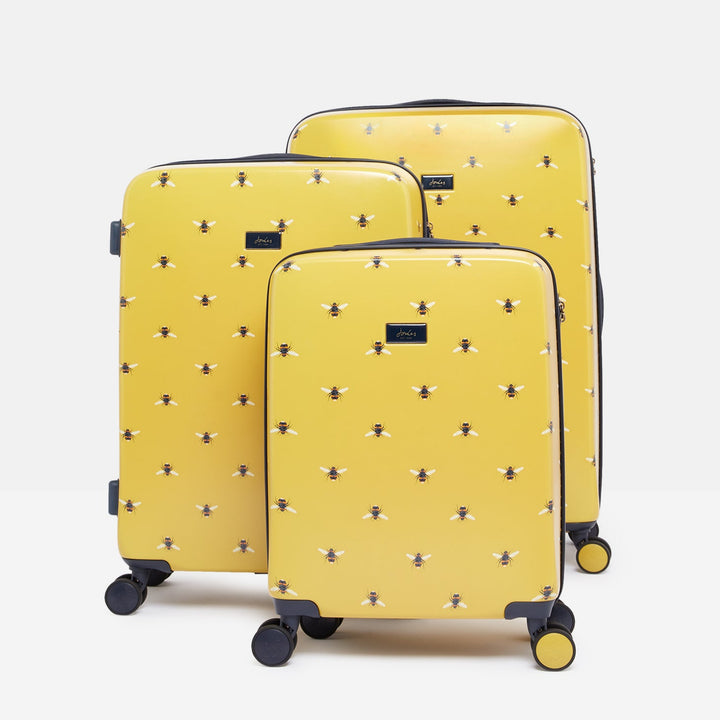 Three yellow suitcases with a pattern on a white background