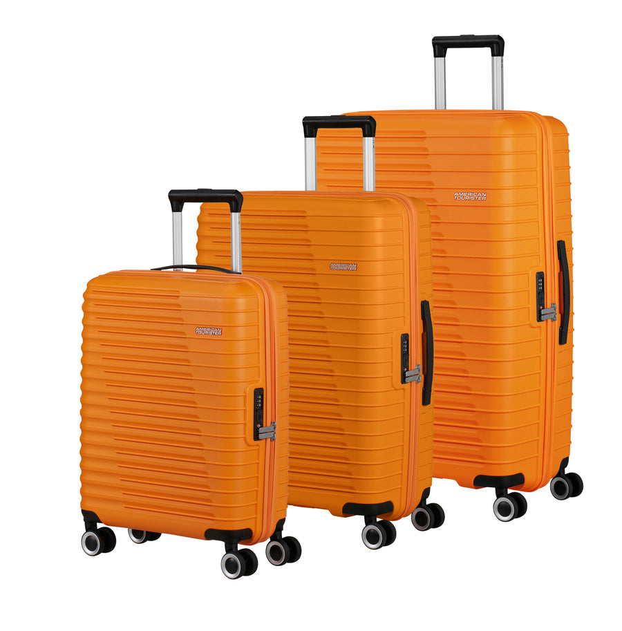 Three orange American Tourister suitcases of different sizes on a white background