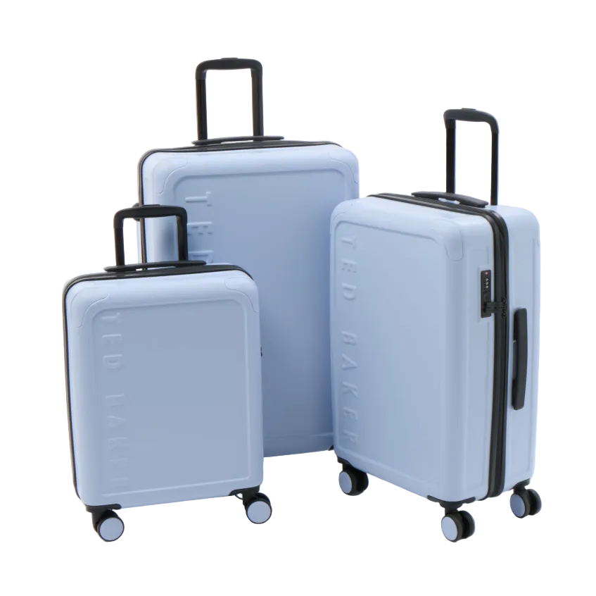 Three light blue hard-shell suitcases in different sizes with black handles and wheels, standing on a white studio background. The embossed brand name 'TED BAKER' is visible on the front of each suitcase.