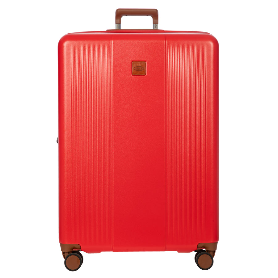 Red Bric's large suitcase with brown wheels and handle on a white background