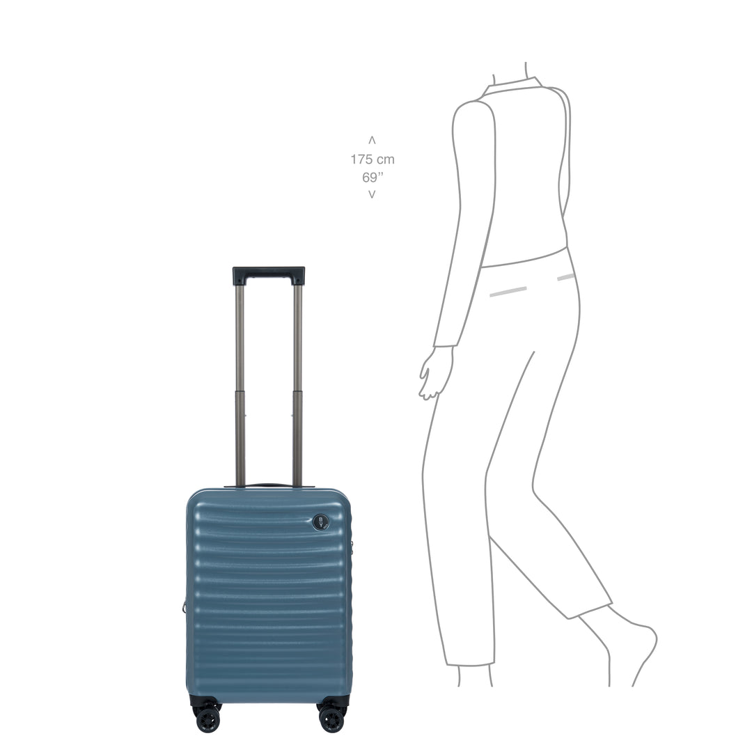 Blue suitcase next to a line drawing of a person for scale on a white background