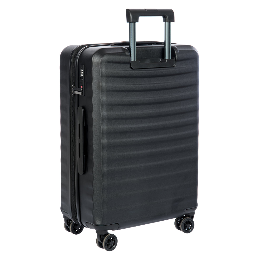 Back of a Black Bric's suitcase with a textured surface on a white background