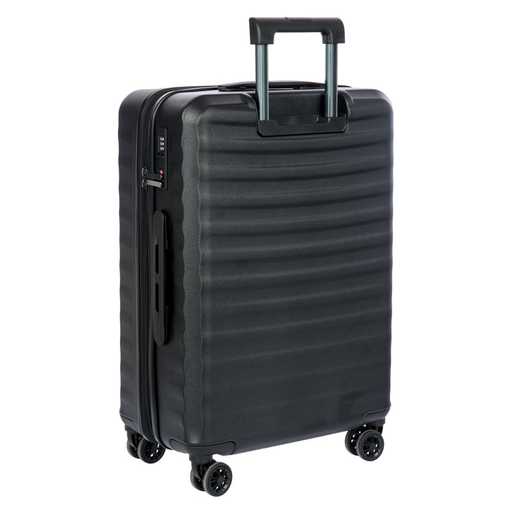 Back of a Black Bric's suitcase with a textured surface on a white background