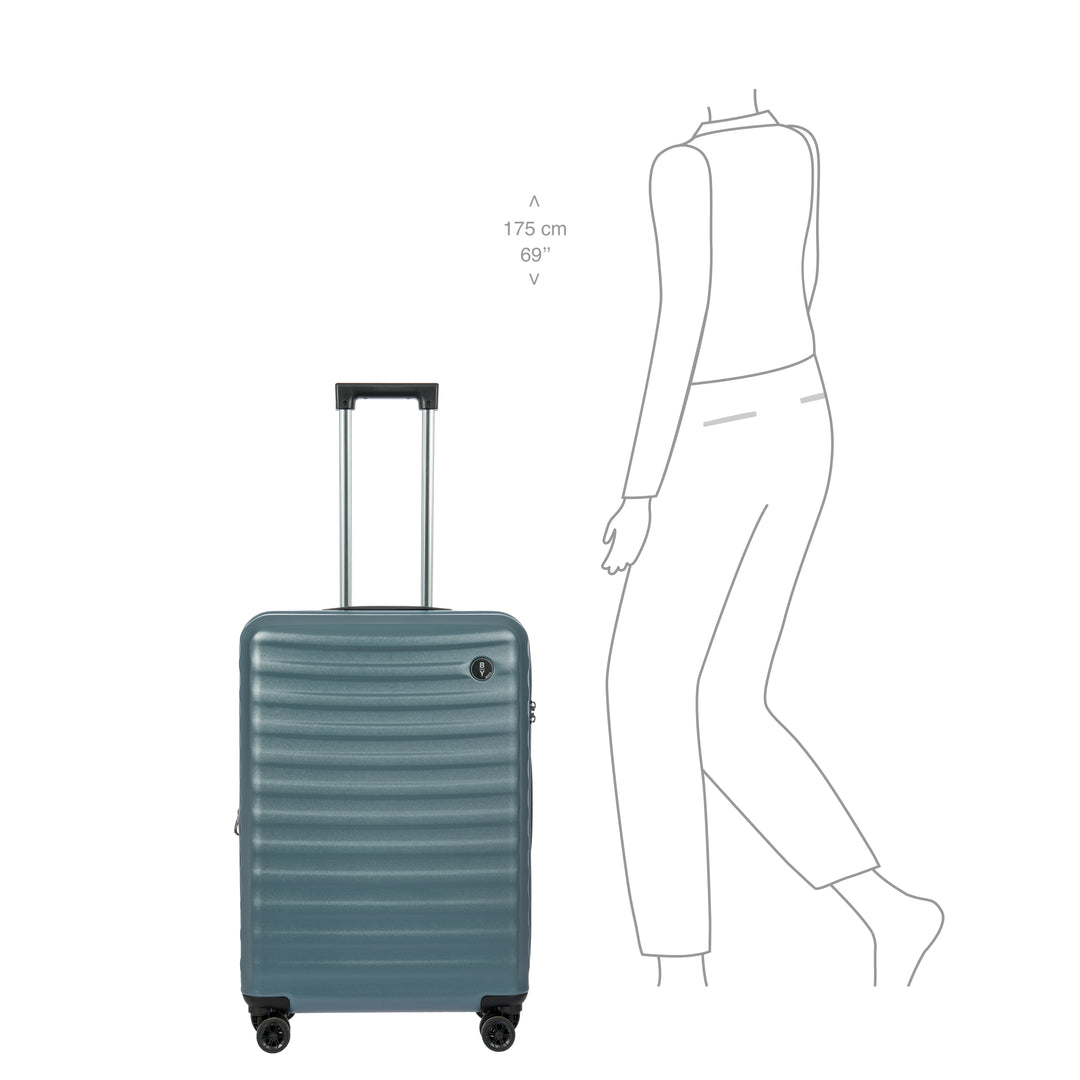 Blue Bric's suitcase with a person for scale on a white background