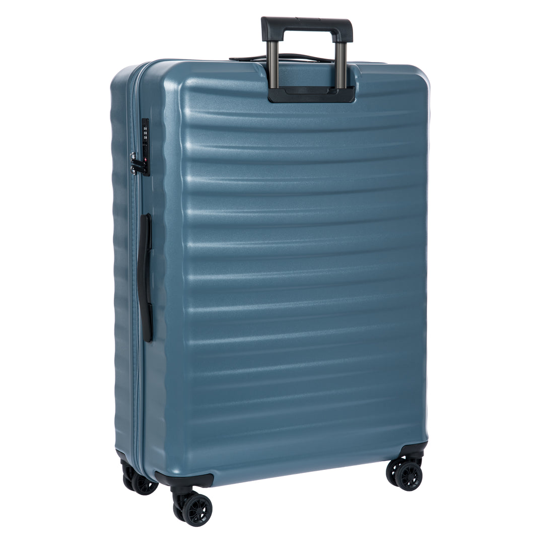 Back of a blue Bric's suitcase with a textured surface on a white background