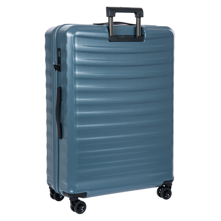 Back of a blue Bric's suitcase with a textured surface on a white background