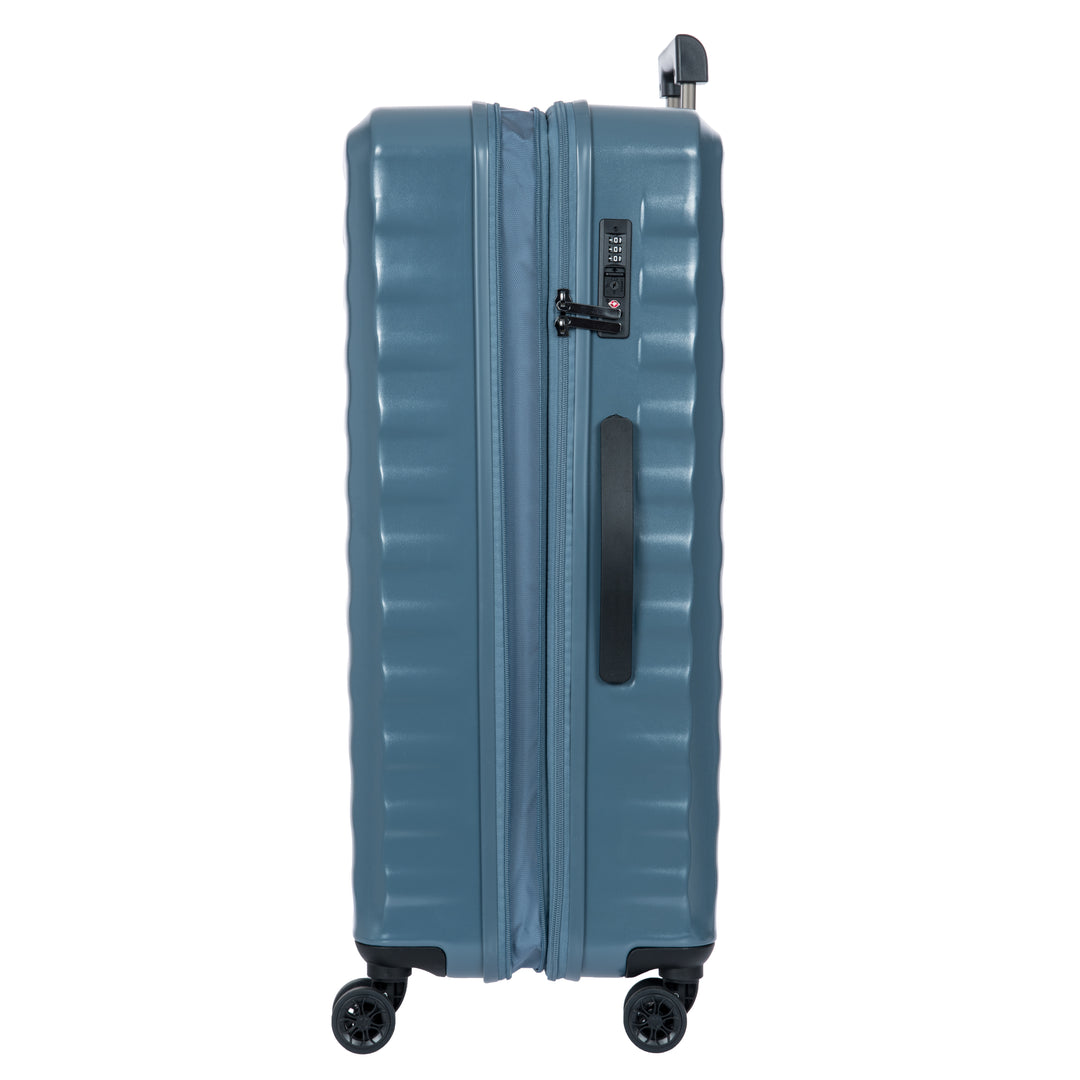 Side of a blue Bric's suitcase with a textured surface on a white background