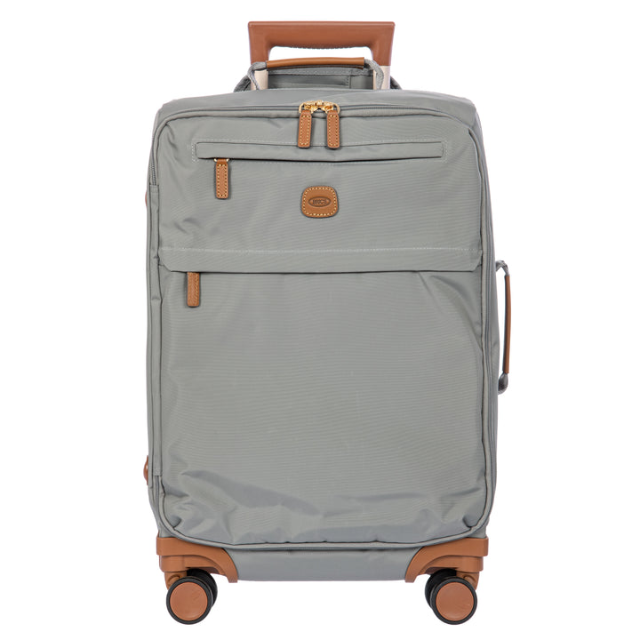 A gray softside spinner suitcase with tan leather-look trim, a top handle, and four wheels, shown on a plain white background.