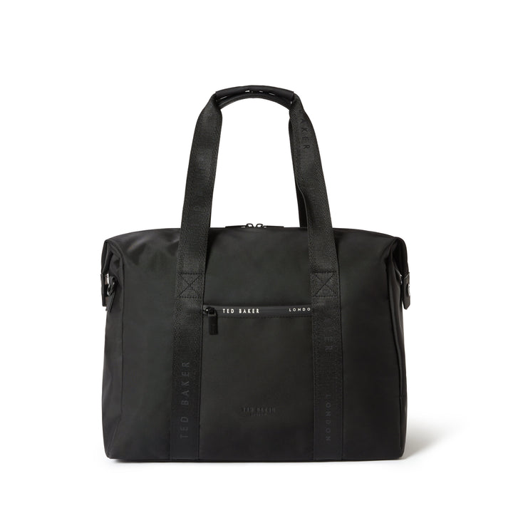 A black nylon tote bag with dual top handles, a front zippered pocket, and vertical branding text on the sides, photographed against a plain white background.