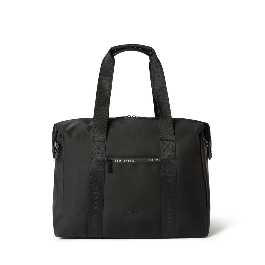 A black nylon tote bag with dual top handles, a front zippered pocket, and vertical branding text on the sides, photographed against a plain white background.