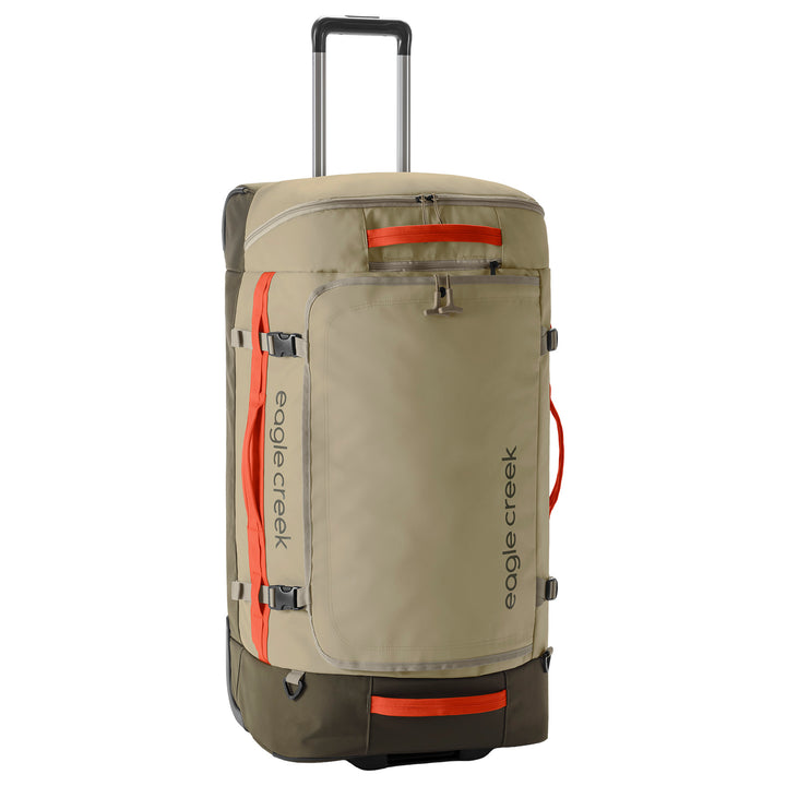 A beige and dark green Eagle Creek rolling suitcase with bright orange accents, including zippers and handles, shown on a solid white background.