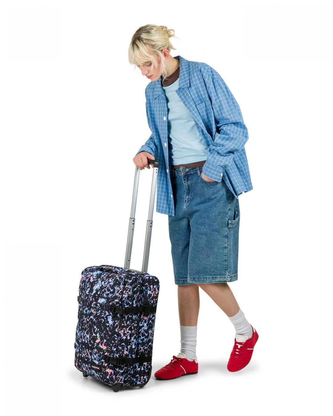 Person with a floral suitcase on a white background
