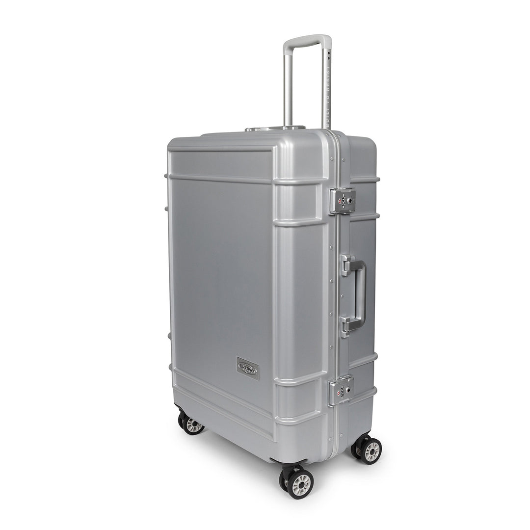 A silver spinner suitcase with an extended telescoping handle, side handle, and four wheels, shown on a plain white background.
