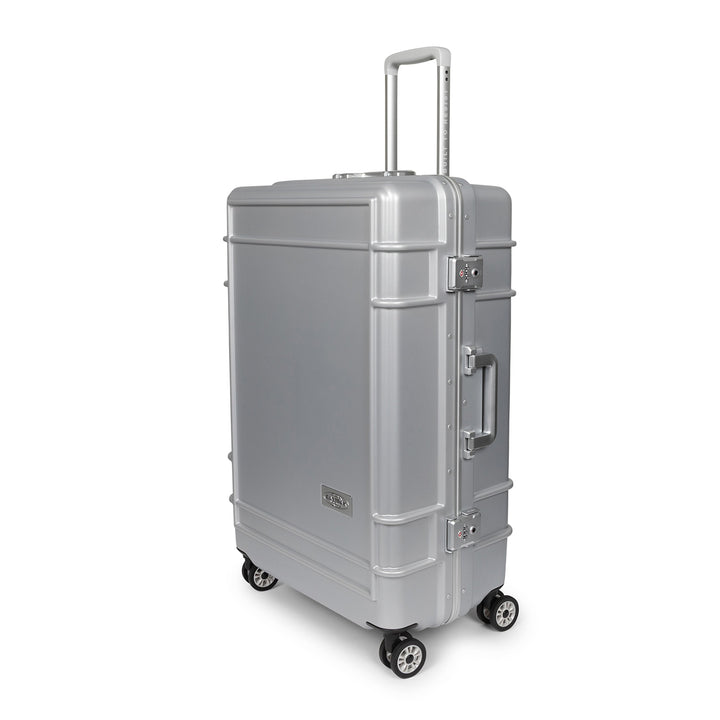 A silver spinner suitcase with an extended telescoping handle, side handle, and four wheels, shown on a plain white background.