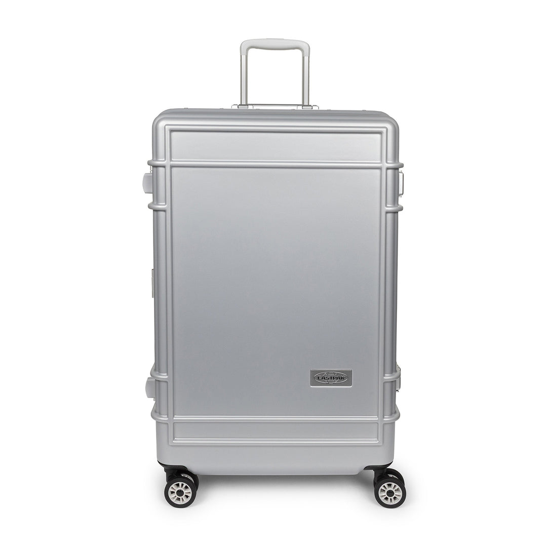 A silver aluminum look spinner suitcase with a telescoping handle extended and four wheels, shown against a plain white background.