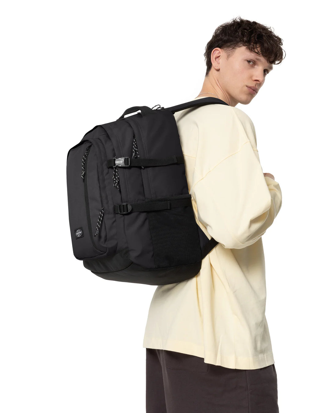 Person wearing a black backpack on a white background