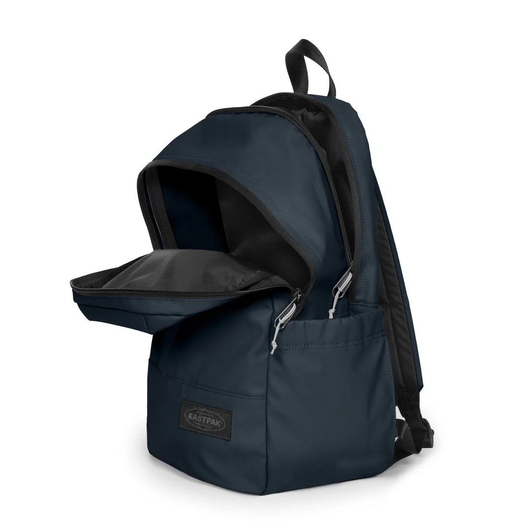A navy blue Eastpak backpack with the front zippered pocket open, showing a black interior lining and silver zipper pulls, set against a plain white background.
