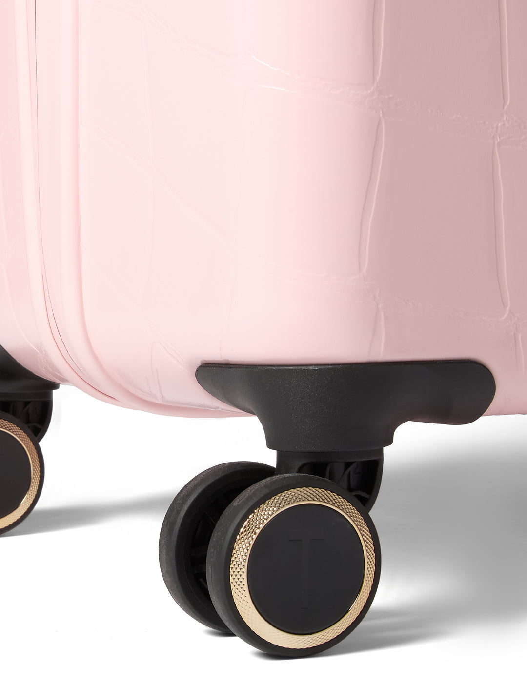 Close-up of a pink suitcase with wheels on a white background
