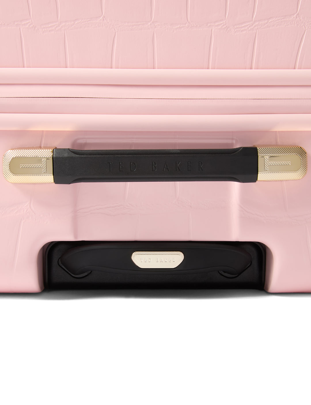 Close-up of a pink suitcase with black and gold handle