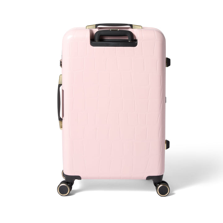 Pink suitcase with gold handle and wheels on a white background