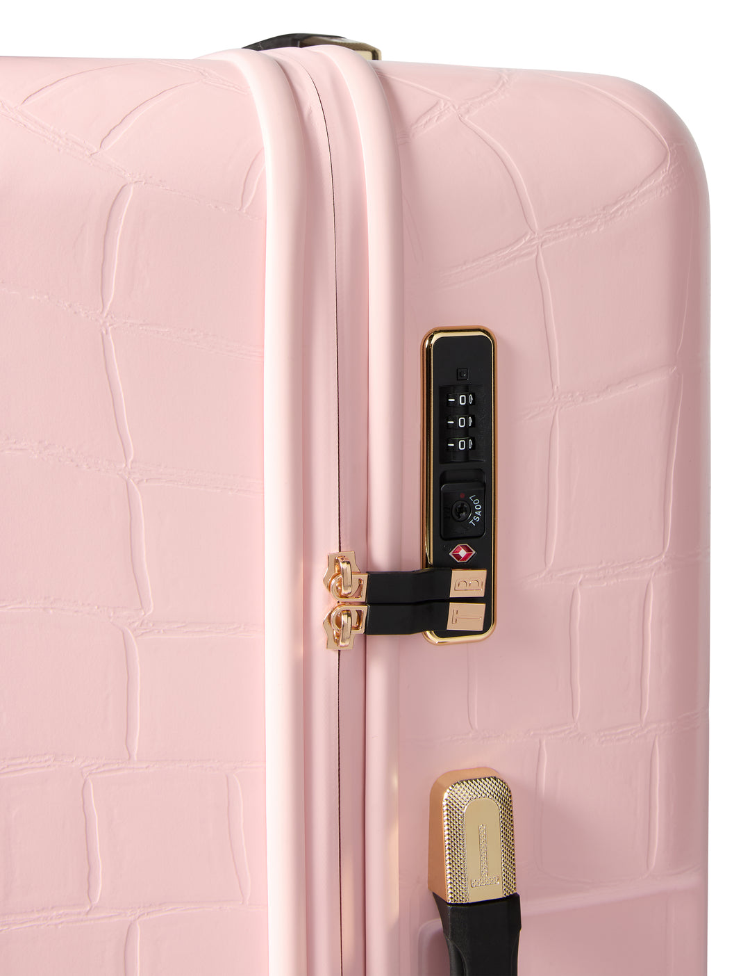 Close-up of a pink textured suitcase with a gold handle and lock.