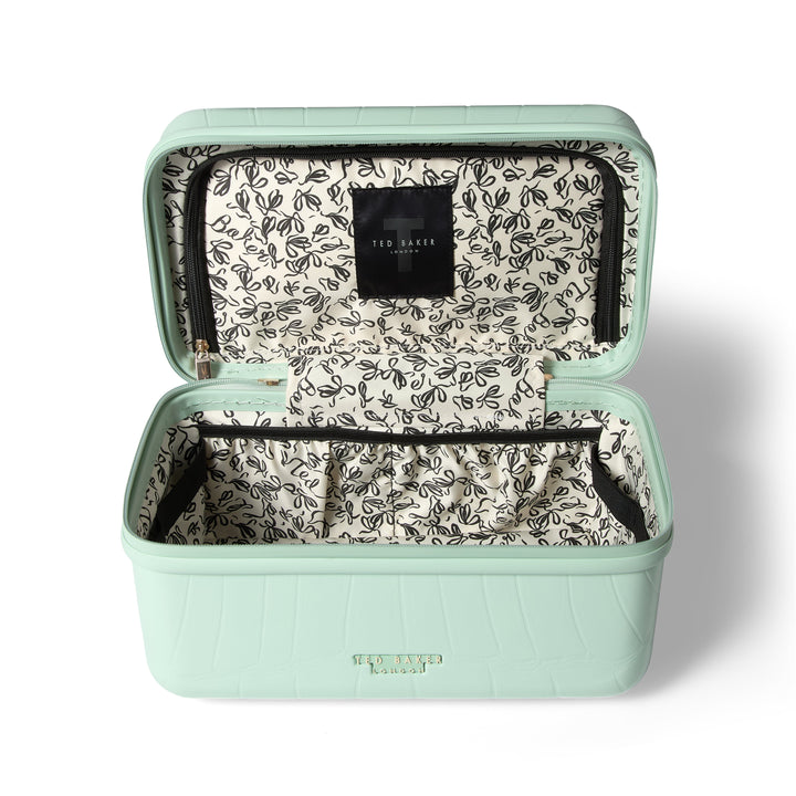 Mint green vanity case with floral interior on a white background
