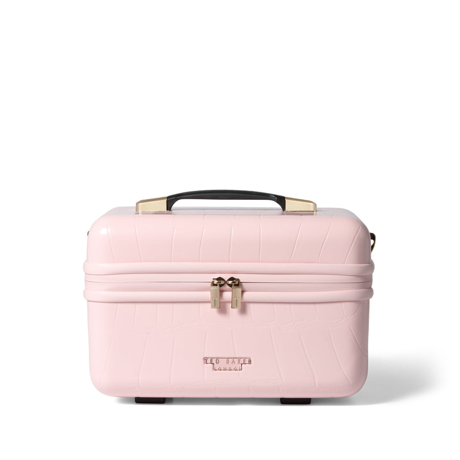 Pink makeup case with gold accents on a white background