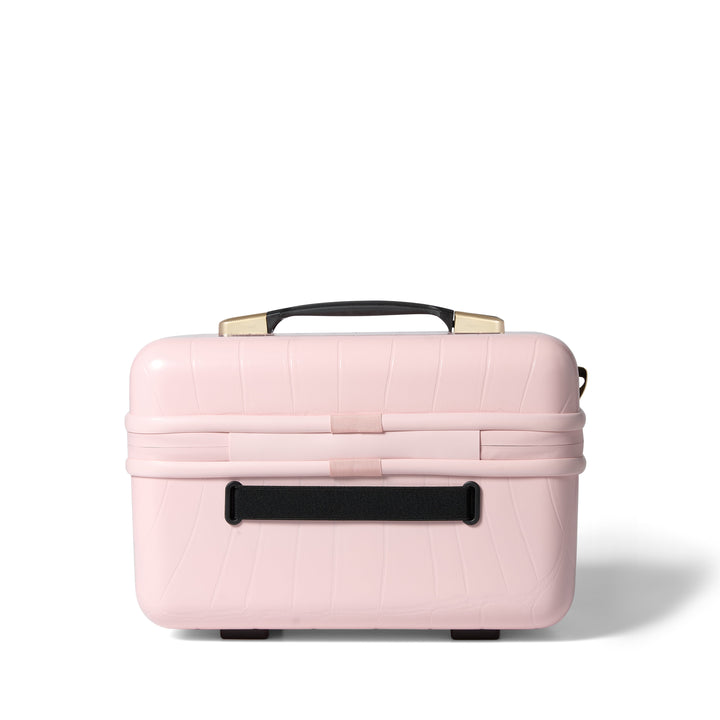 Pink makeup case with gold handle on a white background