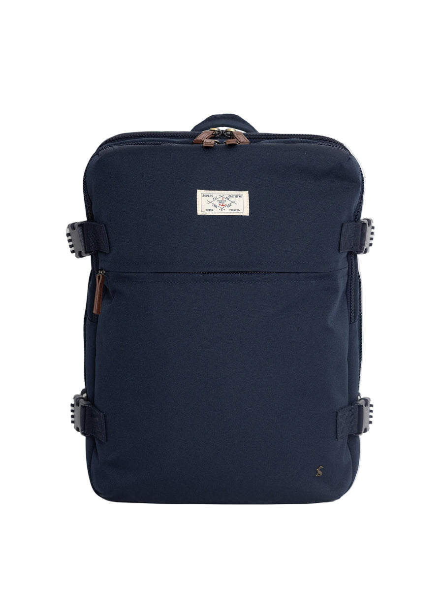 A navy blue backpack with brown leather look accents and a small white brand label on the front, photographed against a clean white background.