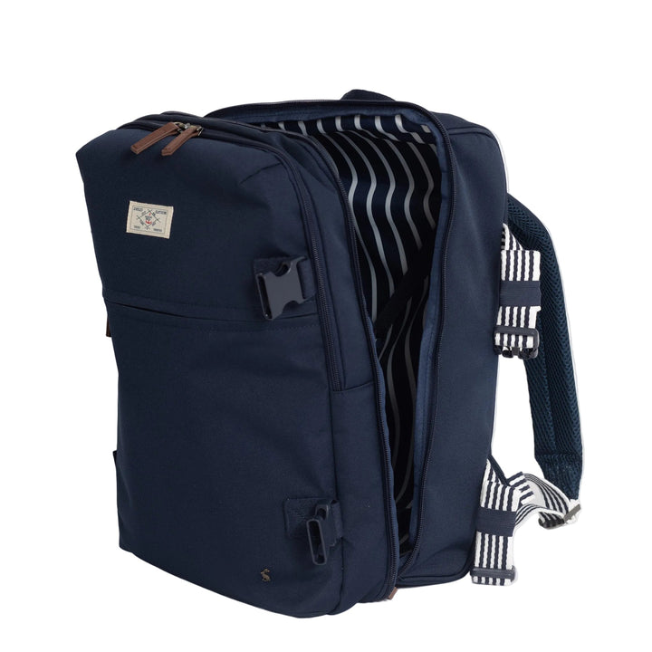 A navy blue backpack shown open, revealing a striped interior lining and black-and-white patterned straps, photographed on a clean light gray background.