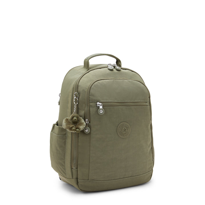 Green backpack with a decorative charm on a white background