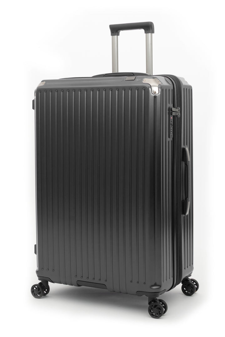 A black ribbed hard-shell suitcase with an extended telescoping handle and four spinner wheels, shown on a clean white background.