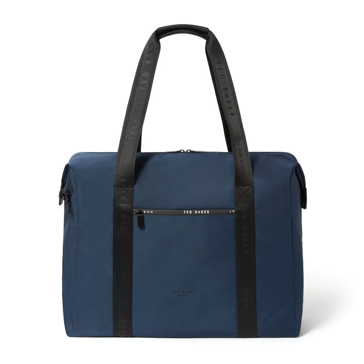 A navy blue Ted Baker travel bag with black shoulder straps and a black front zip pocket, shown on a clean white background.