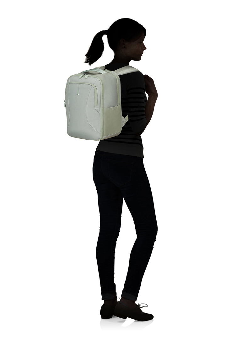 Person wearing a green backpack on a white background