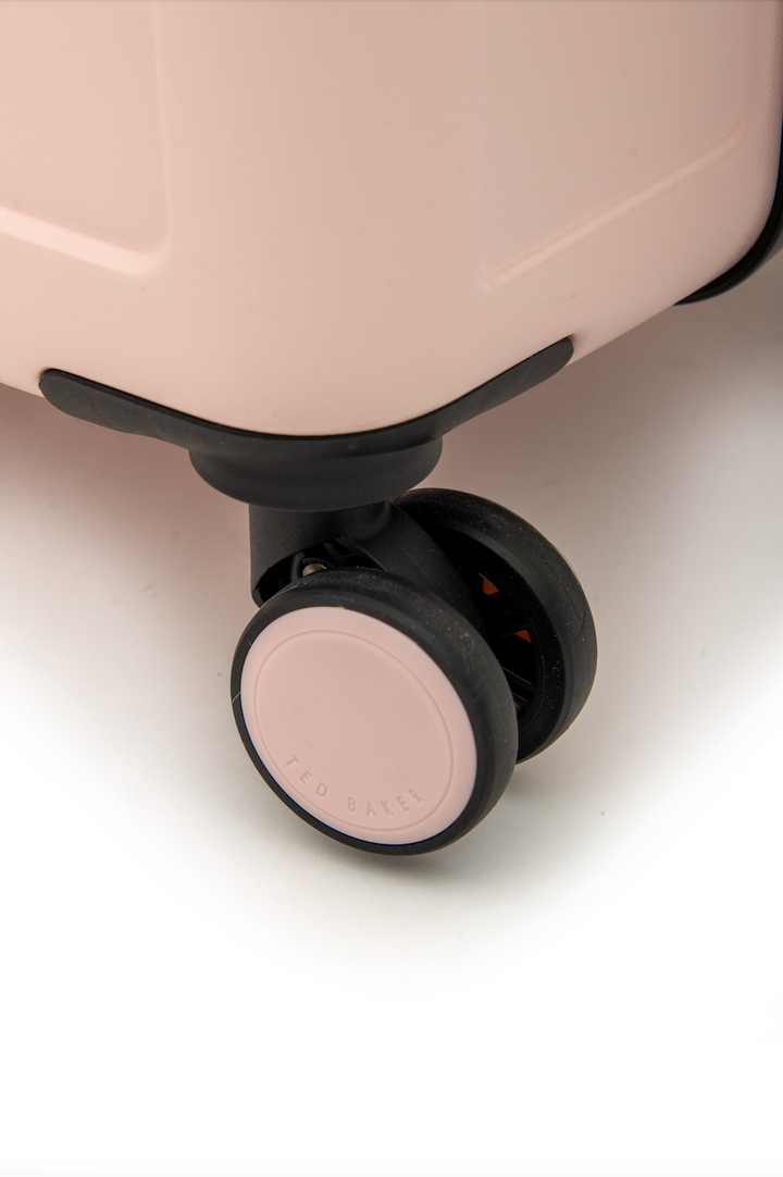 Close-up of a suitcase wheel on a light background