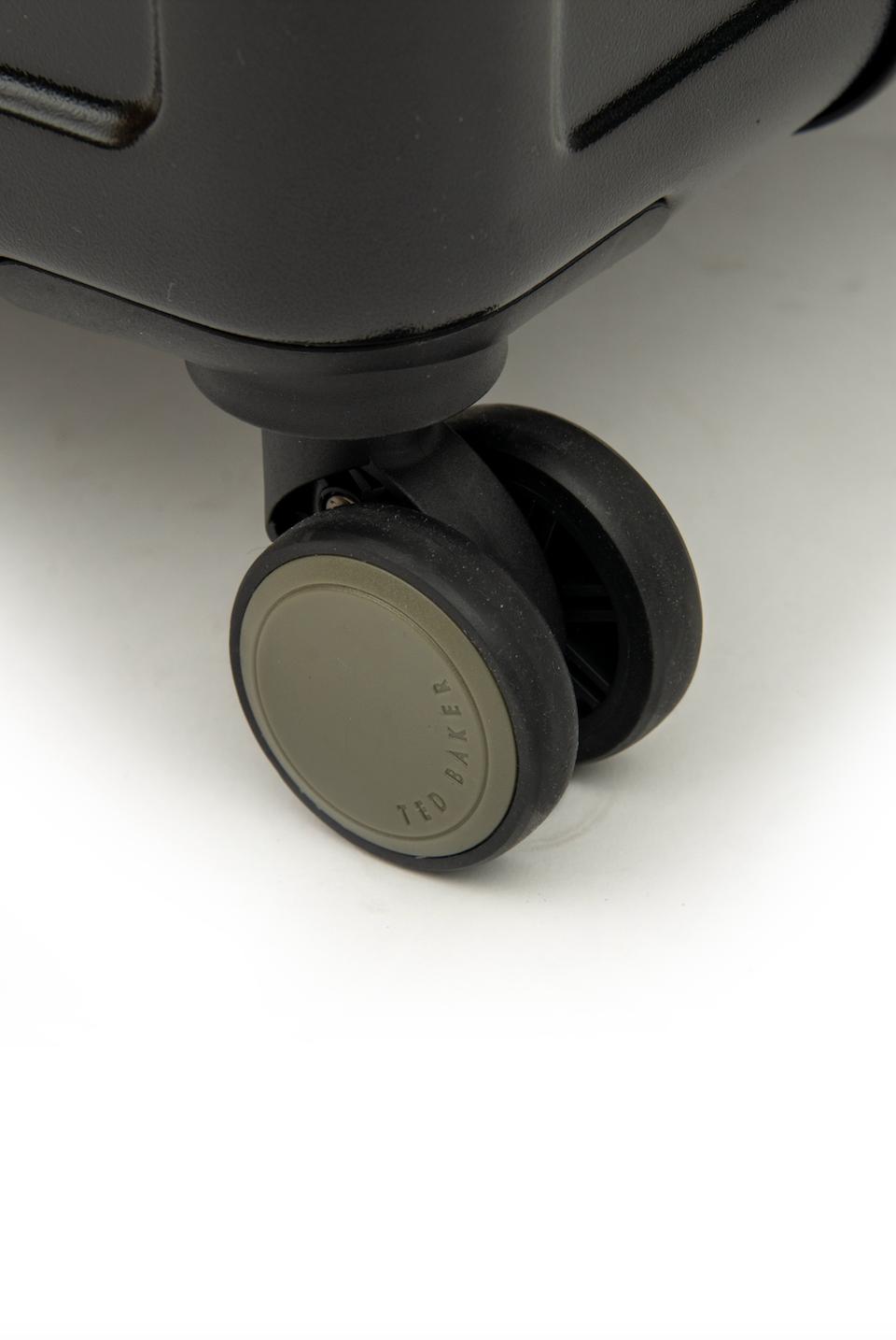 Close-up of a suitcase wheel on a white background