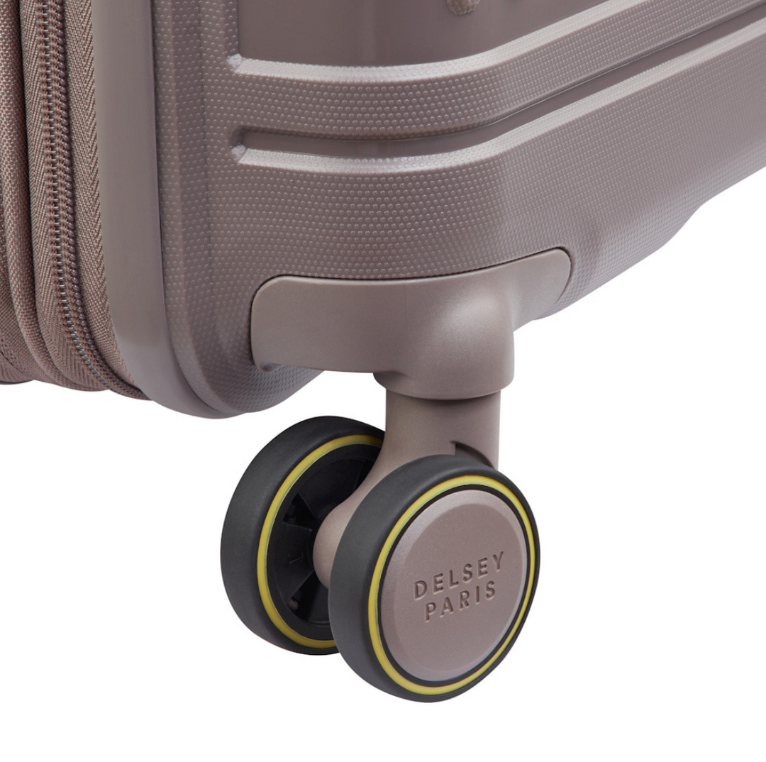 Close-up of a suitcase wheel with 'Delsey Paris' branding on a white background
