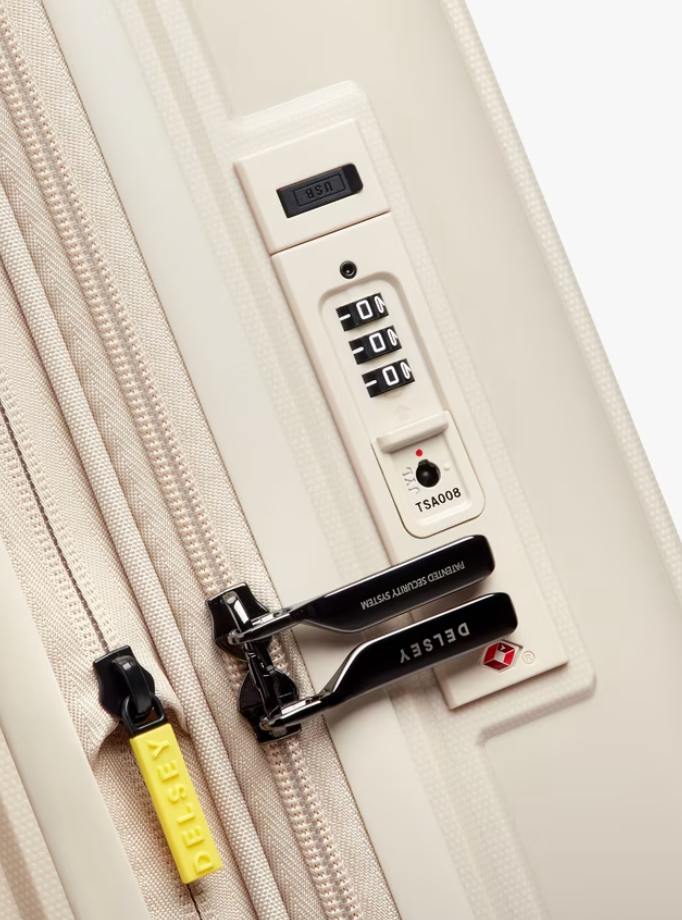 Close-up of a beige suitcase with a black combination lock and yellow tag on a white background