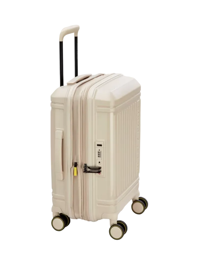 Side angle of a beige Delsey suitcase with 4 wheels on a white background