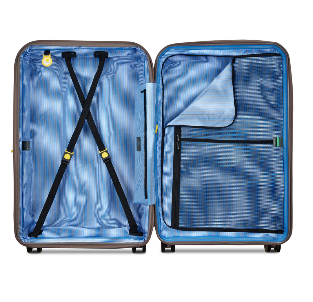 Open Delsey suitcase with blue striped interior and black compression straps on a white background