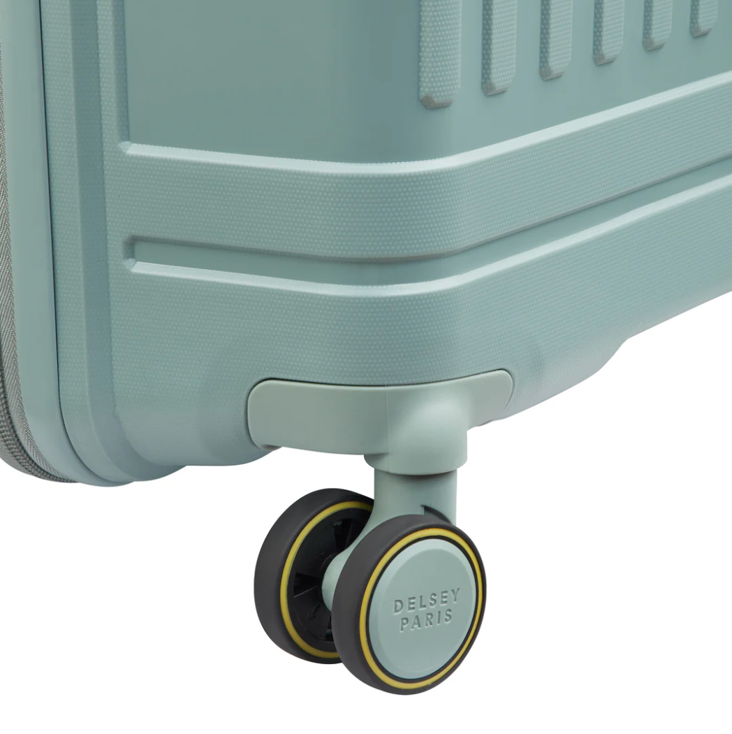 Close-up view of a sage green suitcase wheel with Delsey Paris branding on a white background