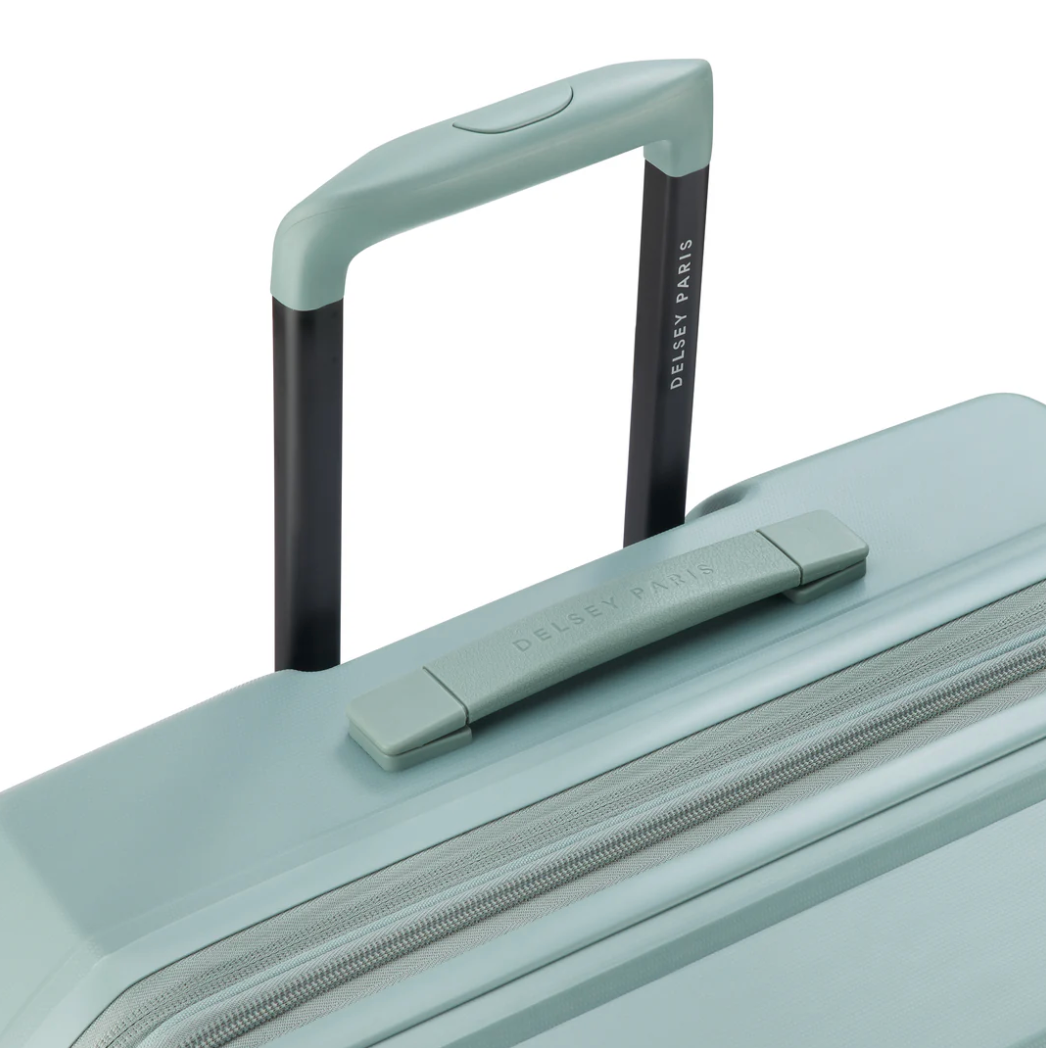 Top view of a sage green Delsey suitcase with top handle and brand logo on a white background