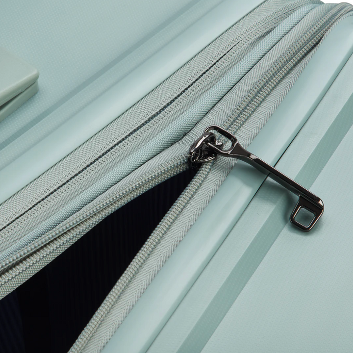 Close-up of a sage green suitcase zip puller with expansion