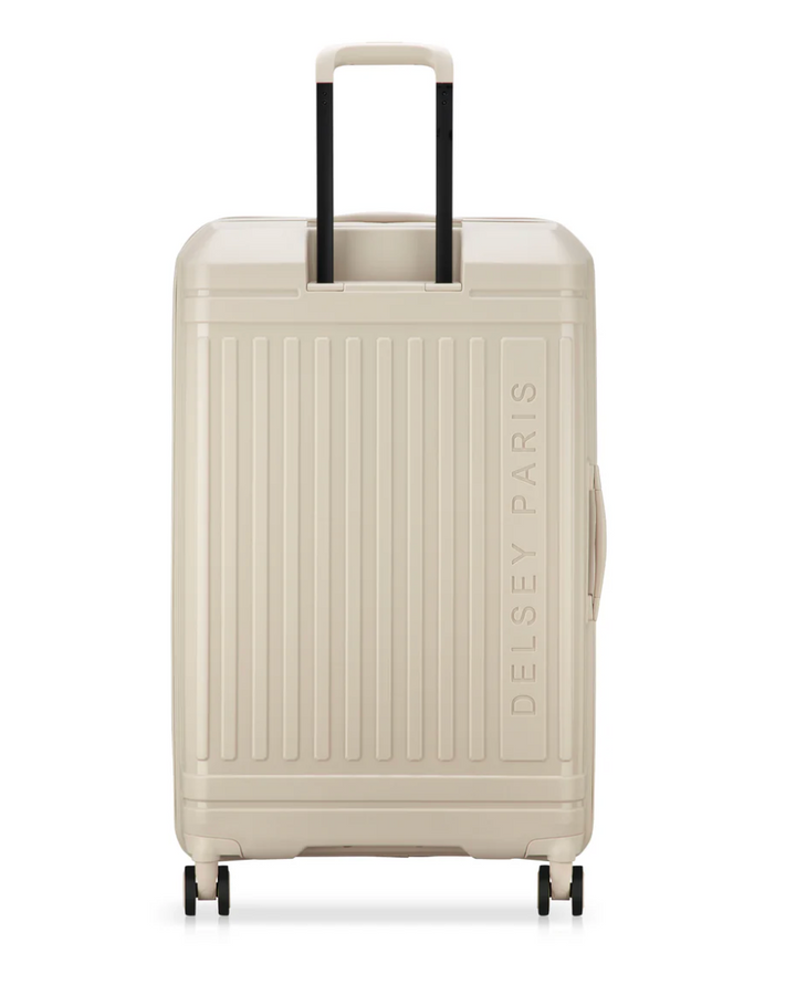 Back of a beige suitcase with 'Delsey Paris' branding on a white background