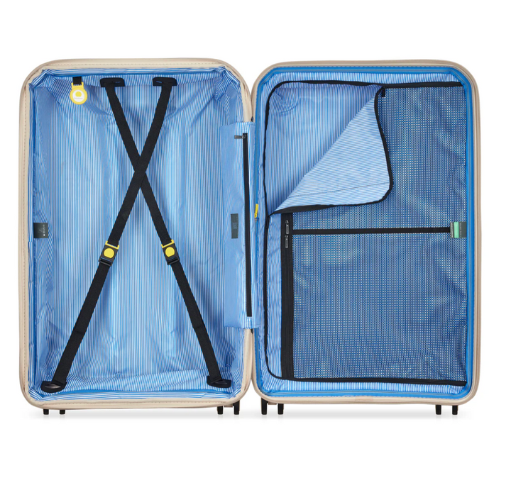 Open Delsey suitcase with blue striped interior and black compression straps on a white background