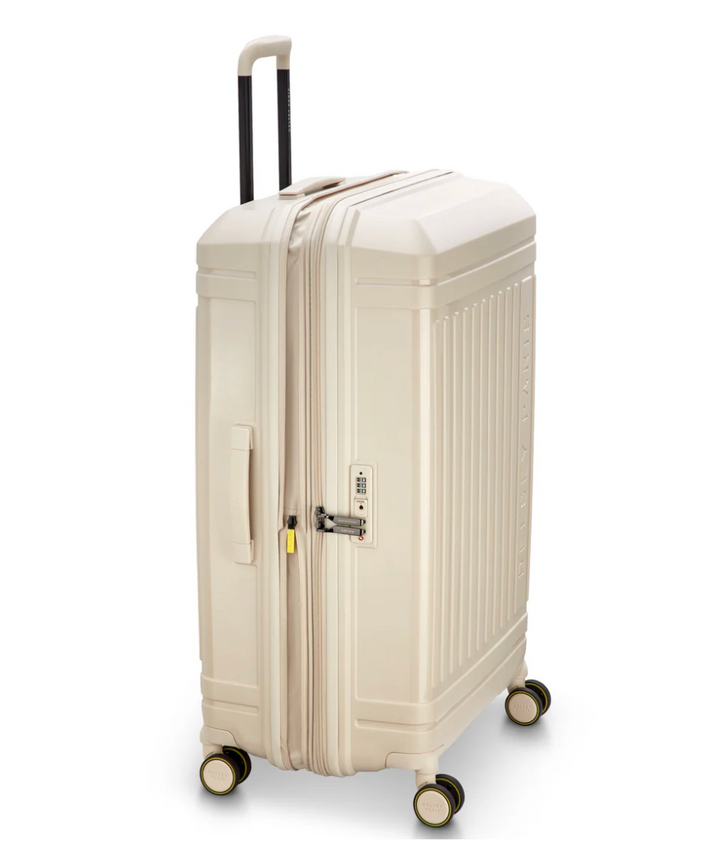 Side angle view of a beige Delsey suitcase with 4 wheels on a white background