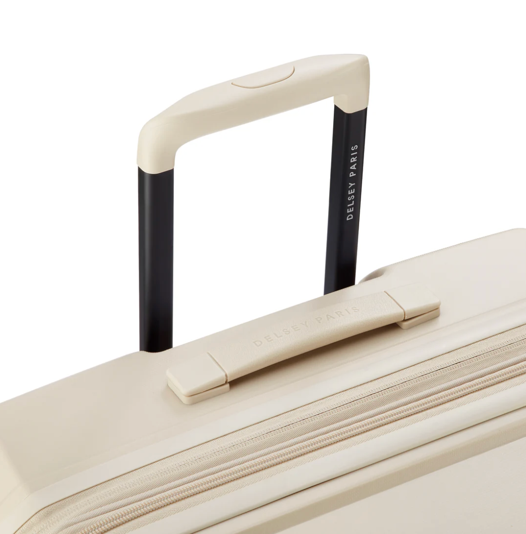 Close-up top view of a beige Delsey suitcase handle with branding on a white background