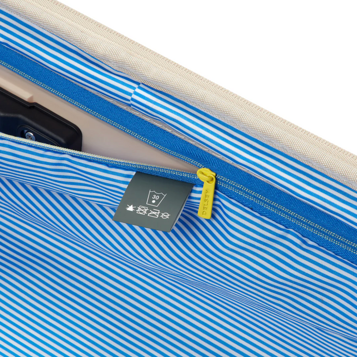 Close-up of a blue and white striped suitcase lining with a label on a white background