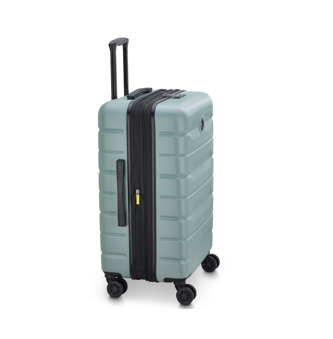 Side angle of a Sage Green Delsey suitcase with black wheels and handle on a white background