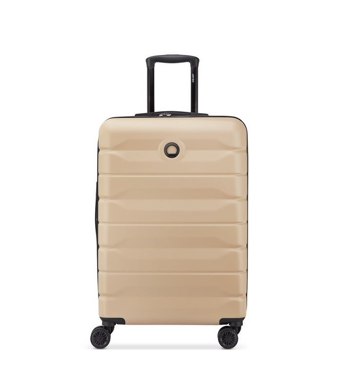 Beige Delsey suitcase with black handle and wheels on a white background